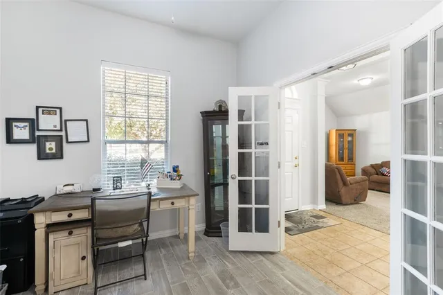 a kitchen with a sink dishwasher a dining table and chairs with wooden floor