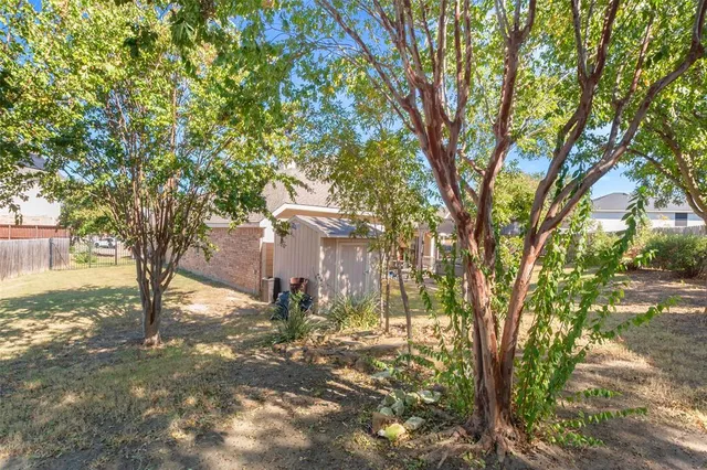 a view of a tree in front of a house