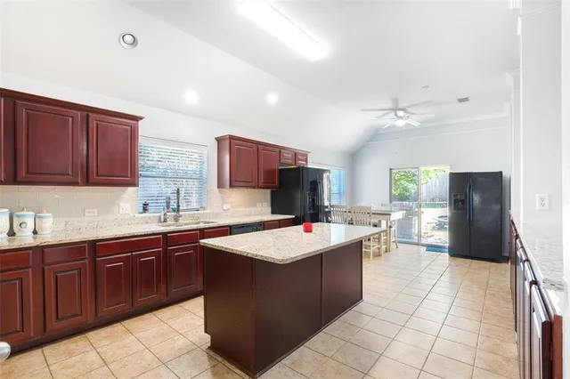 a kitchen with a sink a counter top space a appliances and cabinets