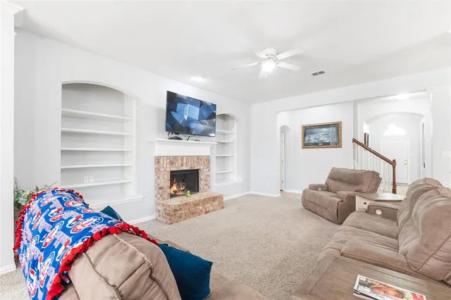 a living room with a fireplace furniture and a flat screen tv