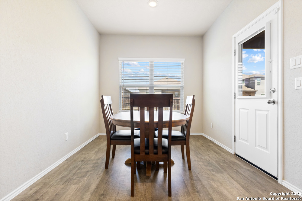 19916 Doc Holiday Drive Lytle, TX 78052 - Photo 13 of 27 a view of a dining room with furniture and wooden floor