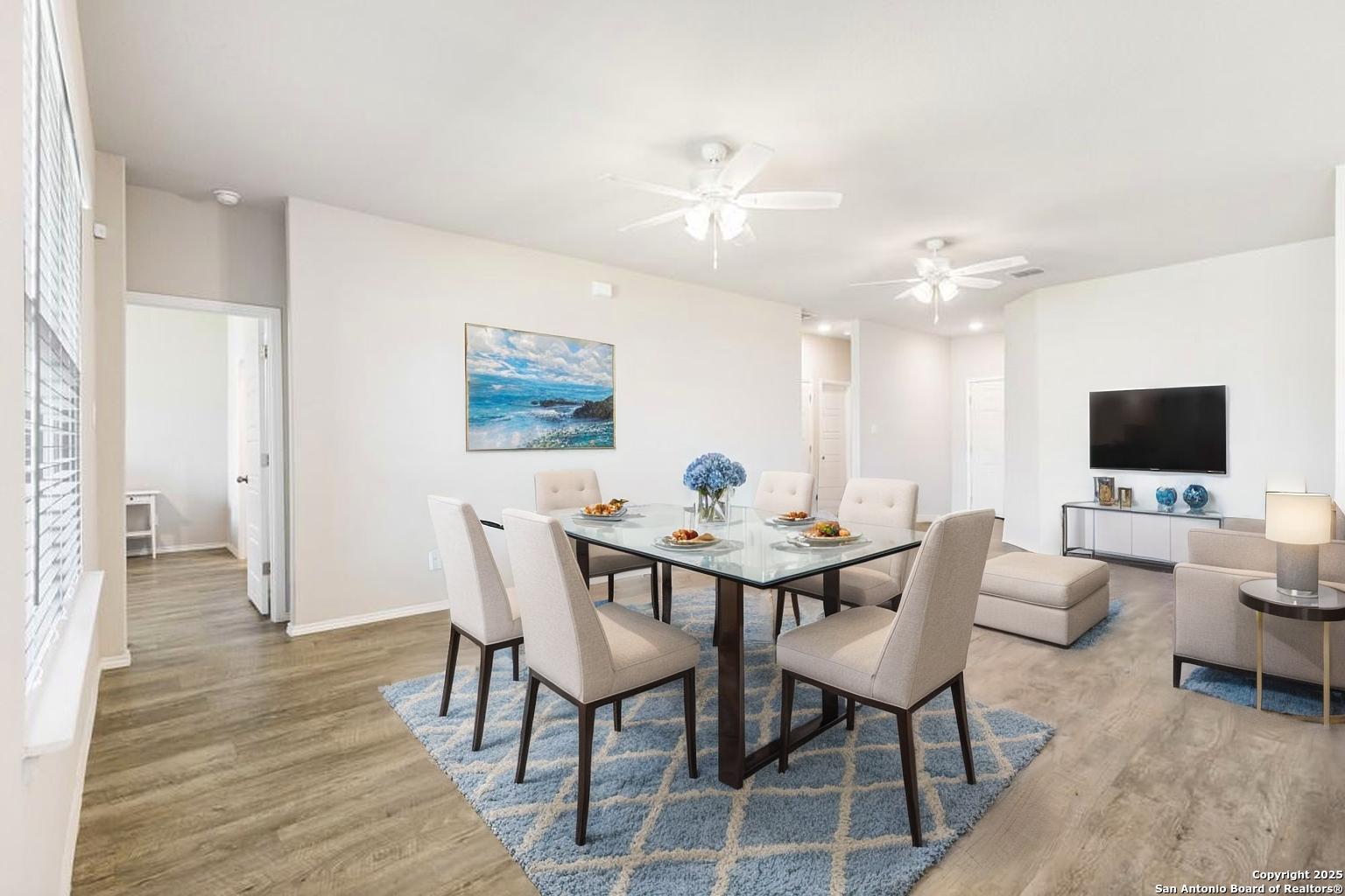 19916 Doc Holiday Drive Lytle, TX 78052 - Photo 14 of 27 a view of a dining room with furniture and wooden floor