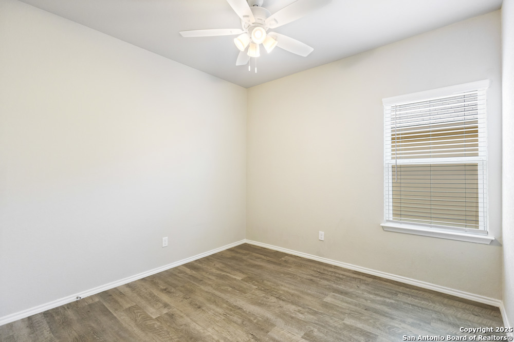 19916 Doc Holiday Drive Lytle, TX 78052 - Photo 19 of 27 an empty room with a window and a fan