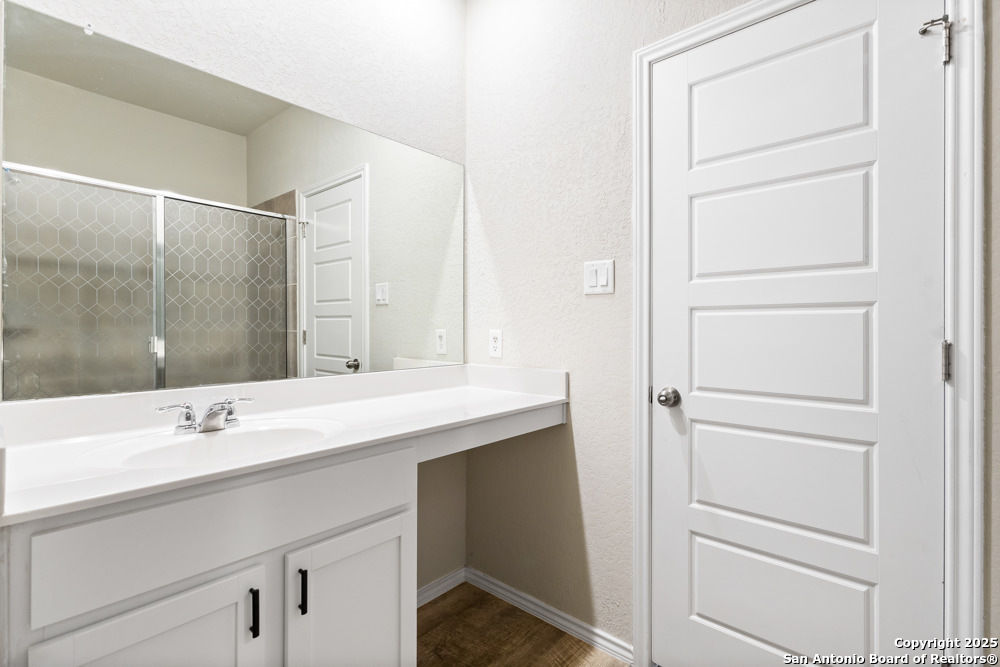 19916 Doc Holiday Drive Lytle, TX 78052 - Photo 21 of 27 a bathroom with a sink and a mirror