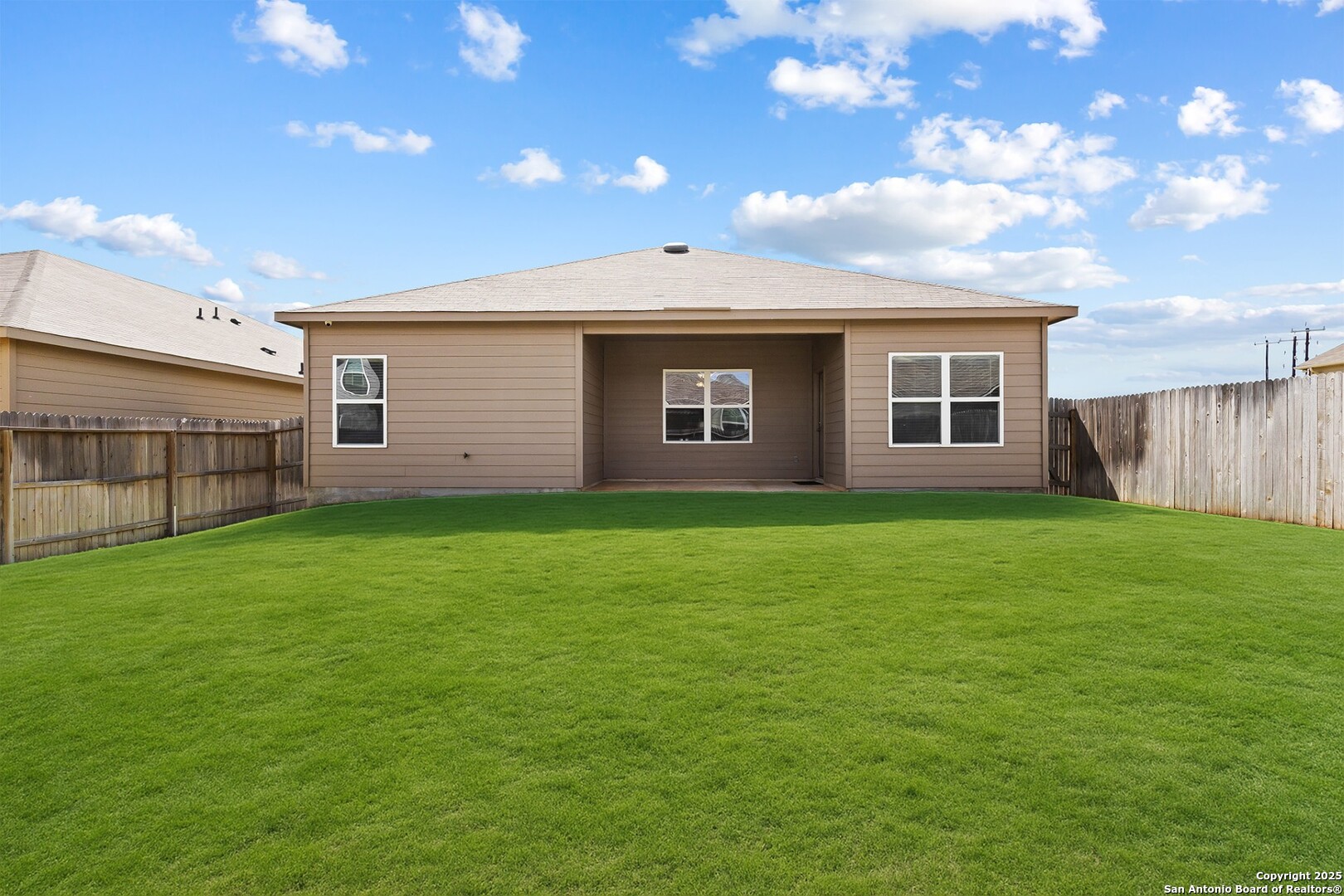 19916 Doc Holiday Drive Lytle, TX 78052 - Photo 26 of 27 a view of a house with a yard