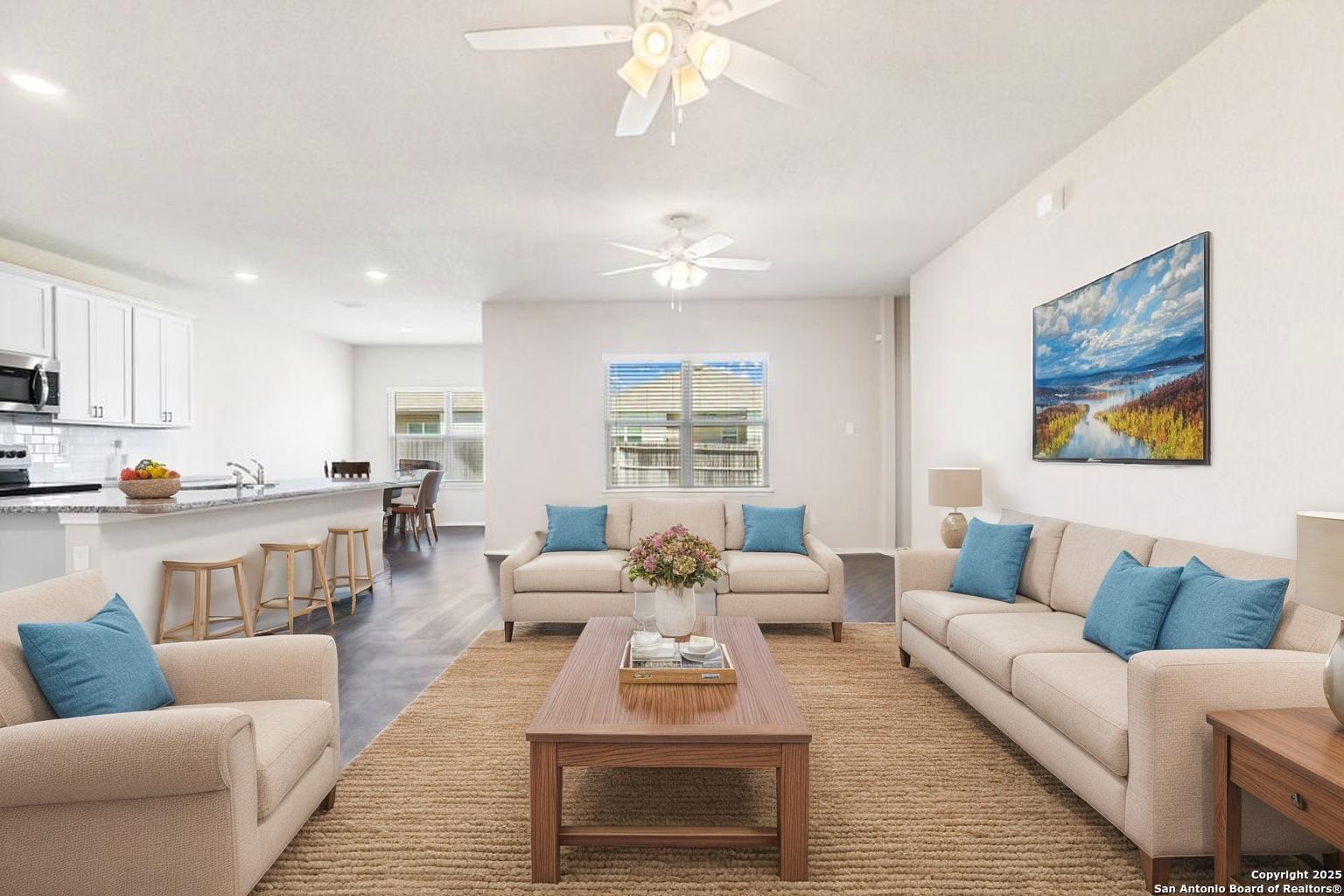 19916 Doc Holiday Drive Lytle, TX 78052 - Photo 4 of 27 a living room with furniture wooden floor and a fireplace
