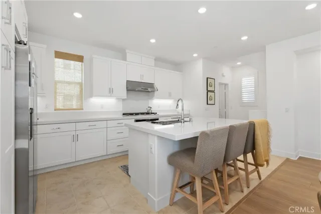 a stove top oven sitting inside of a kitchen
