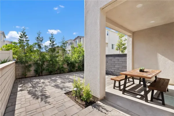 a view of a porch with furniture and garden