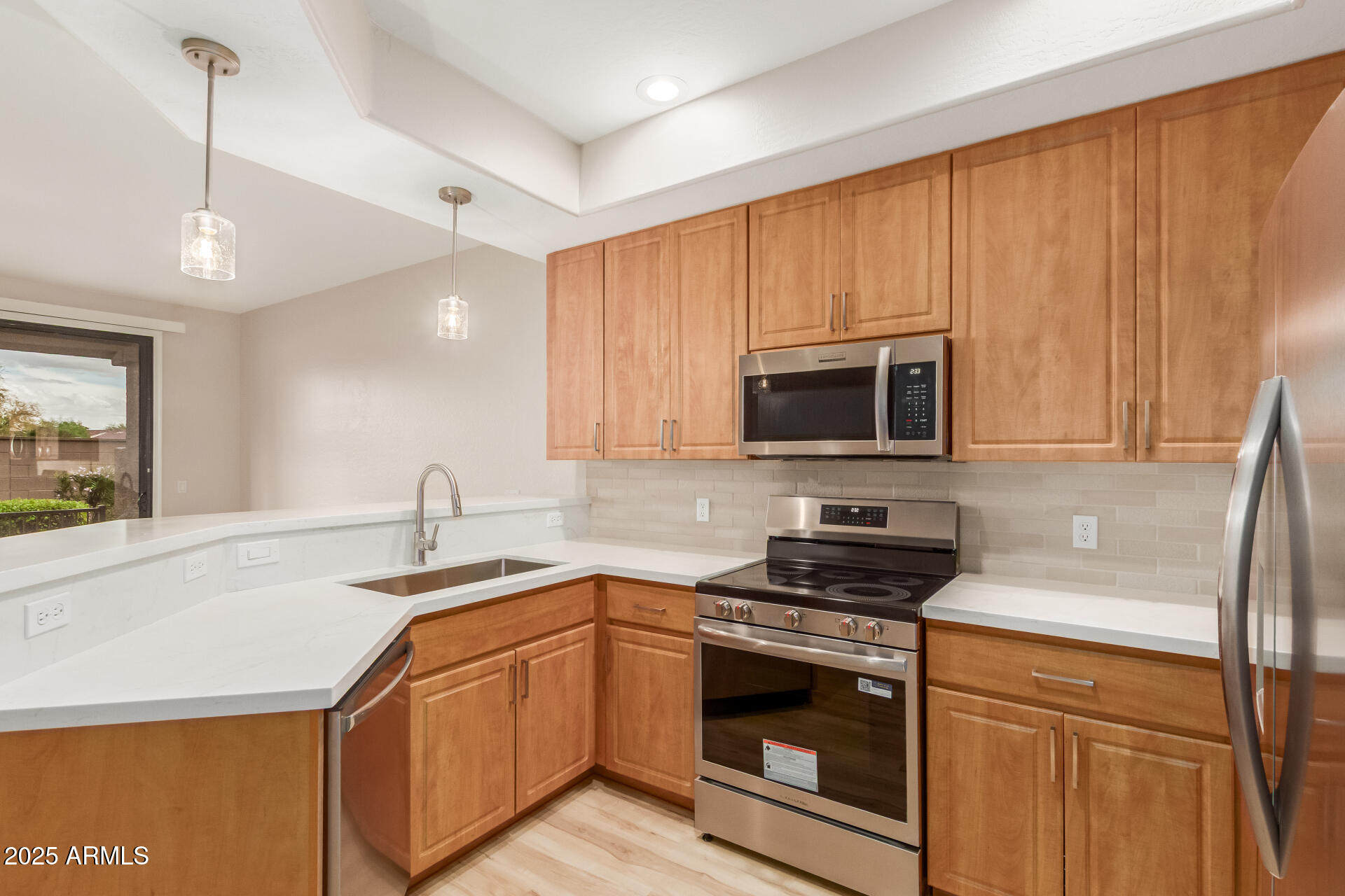 705 West Queen Creek Road, Unit 1208 Chandler, AZ 85248 - Photo 12 of 43 a kitchen with stainless steel appliances a stove a sink a microwave a refrigerator and cabinets