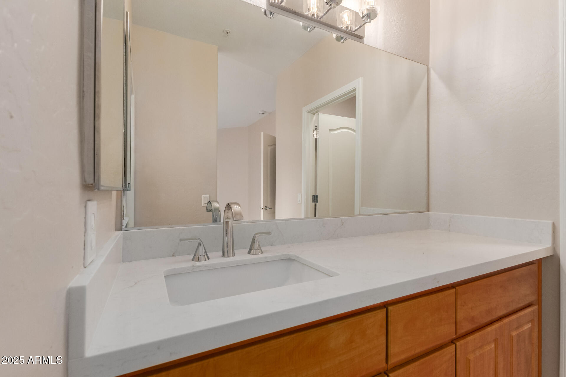 705 West Queen Creek Road, Unit 1208 Chandler, AZ 85248 - Photo 19 of 39 a bathroom with a sink and a mirror
