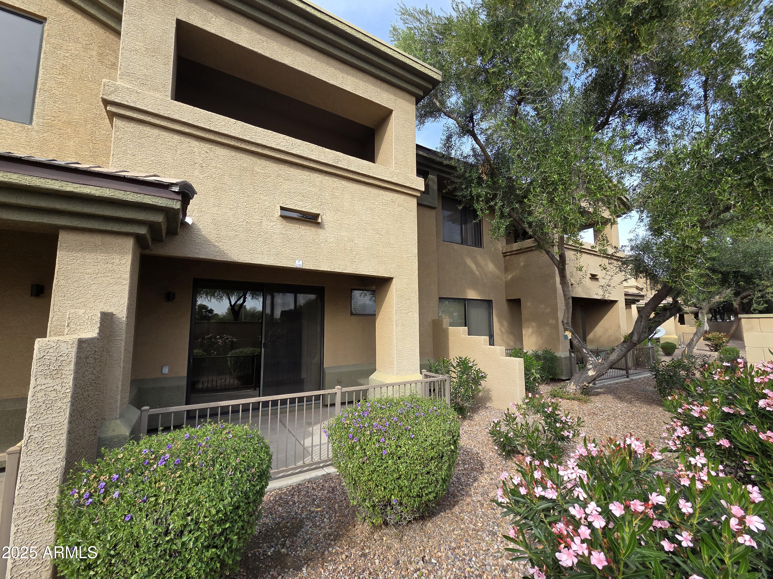 705 West Queen Creek Road, Unit 1208 Chandler, AZ 85248 - Photo 23 of 39 a front view of a house with garden
