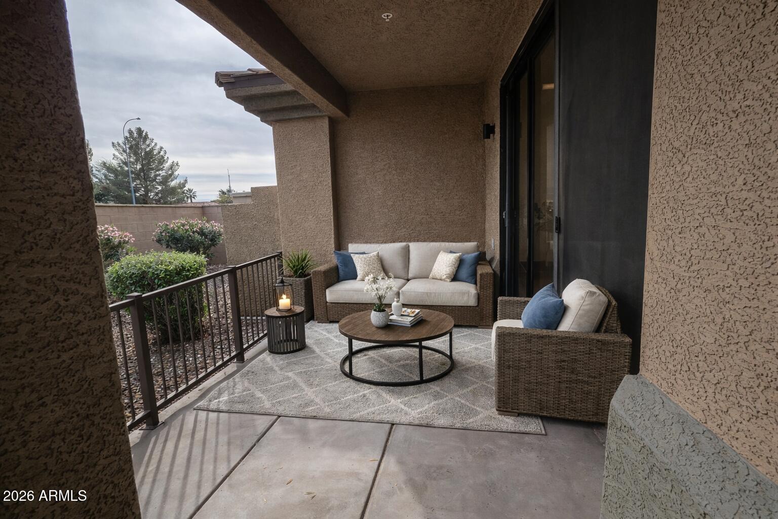 705 West Queen Creek Road, Unit 1208 Chandler, AZ 85248 - Photo 28 of 43 a balcony with couch and chairs