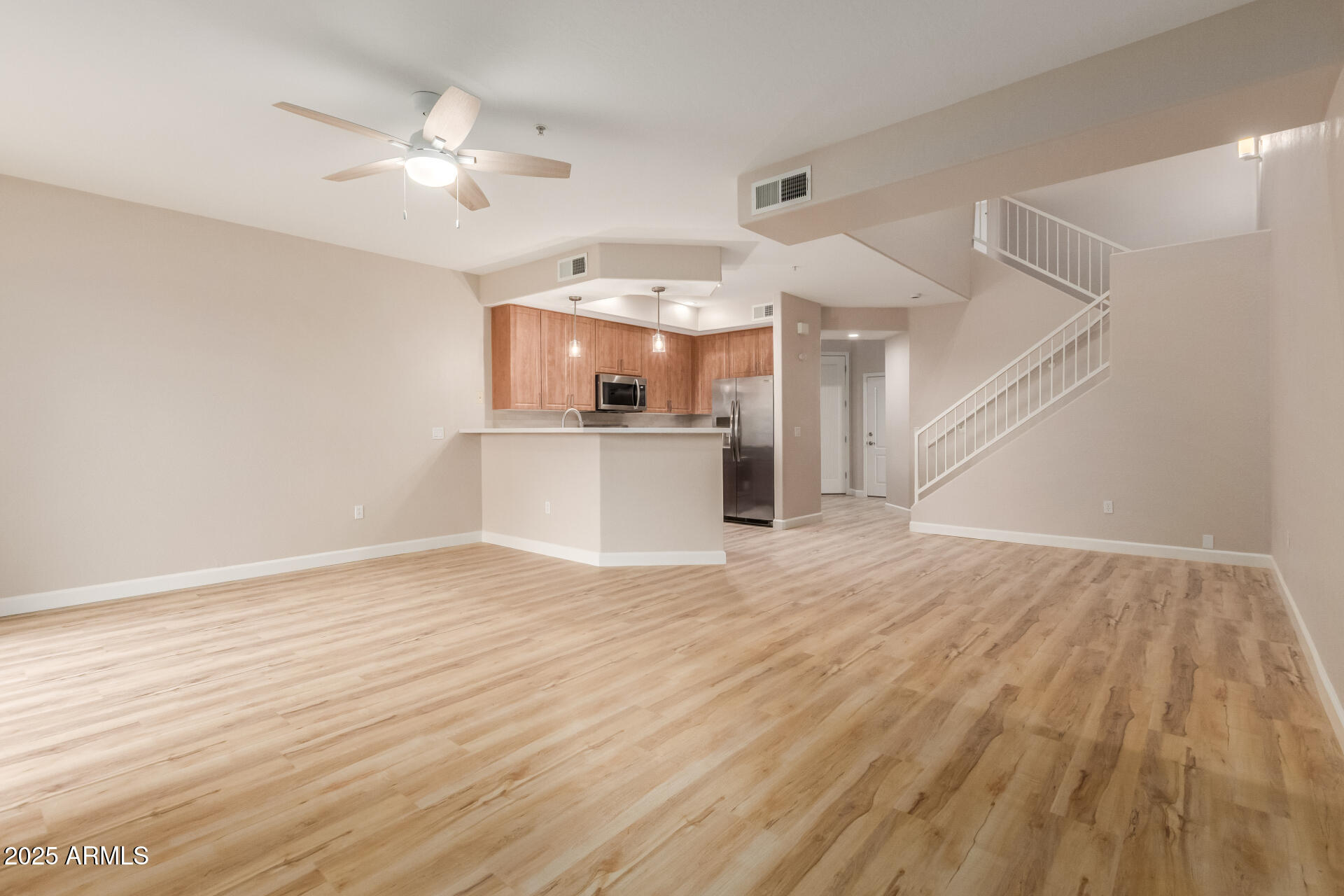 705 West Queen Creek Road, Unit 1208 Chandler, AZ 85248 - Photo 6 of 43 a view of a kitchen with wooden floor and a ceiling fan