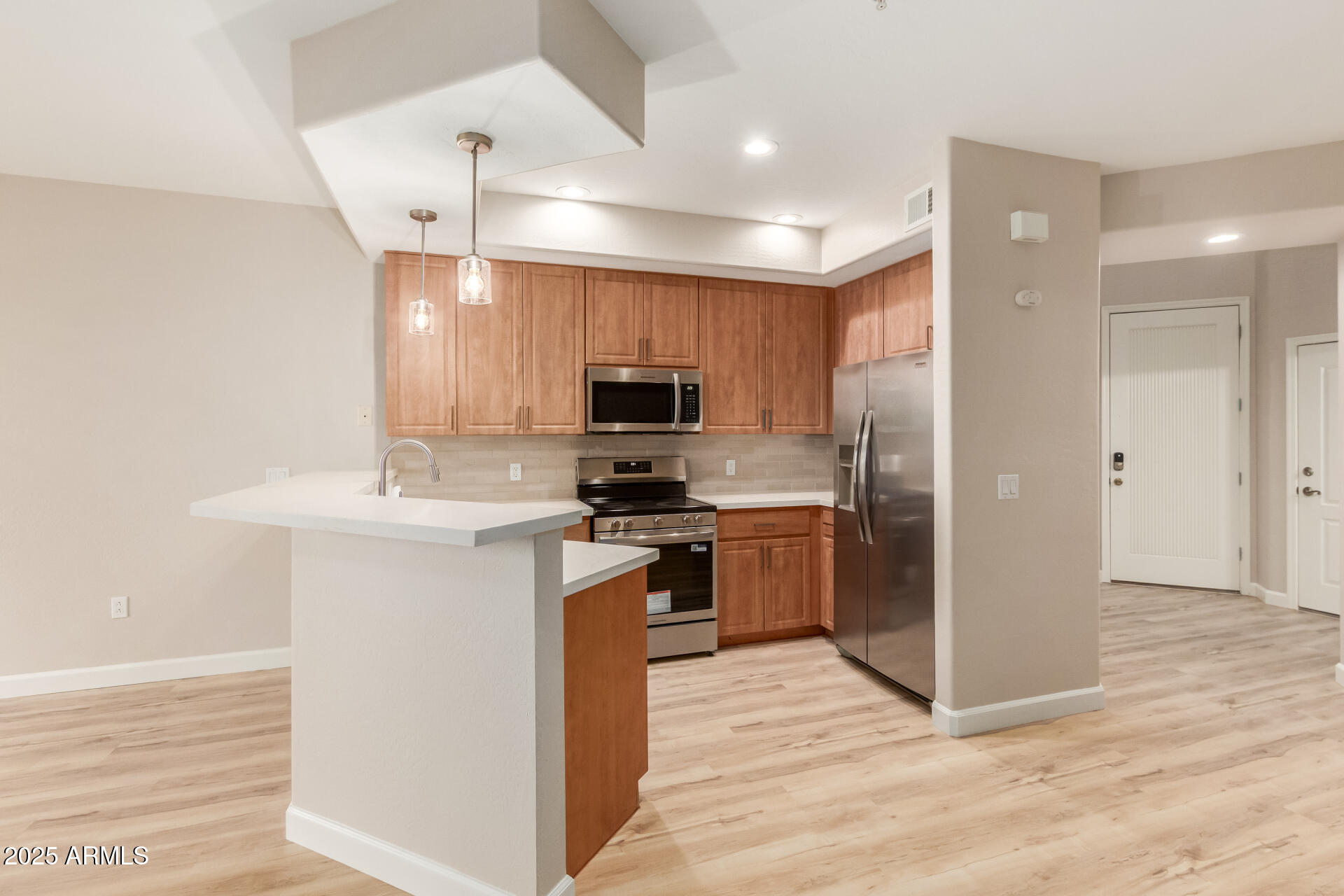 705 West Queen Creek Road, Unit 1208 Chandler, AZ 85248 - Photo 8 of 39 a kitchen with stainless steel appliances granite countertop a refrigerator a sink a stove top oven and a refrigerator with wooden floor