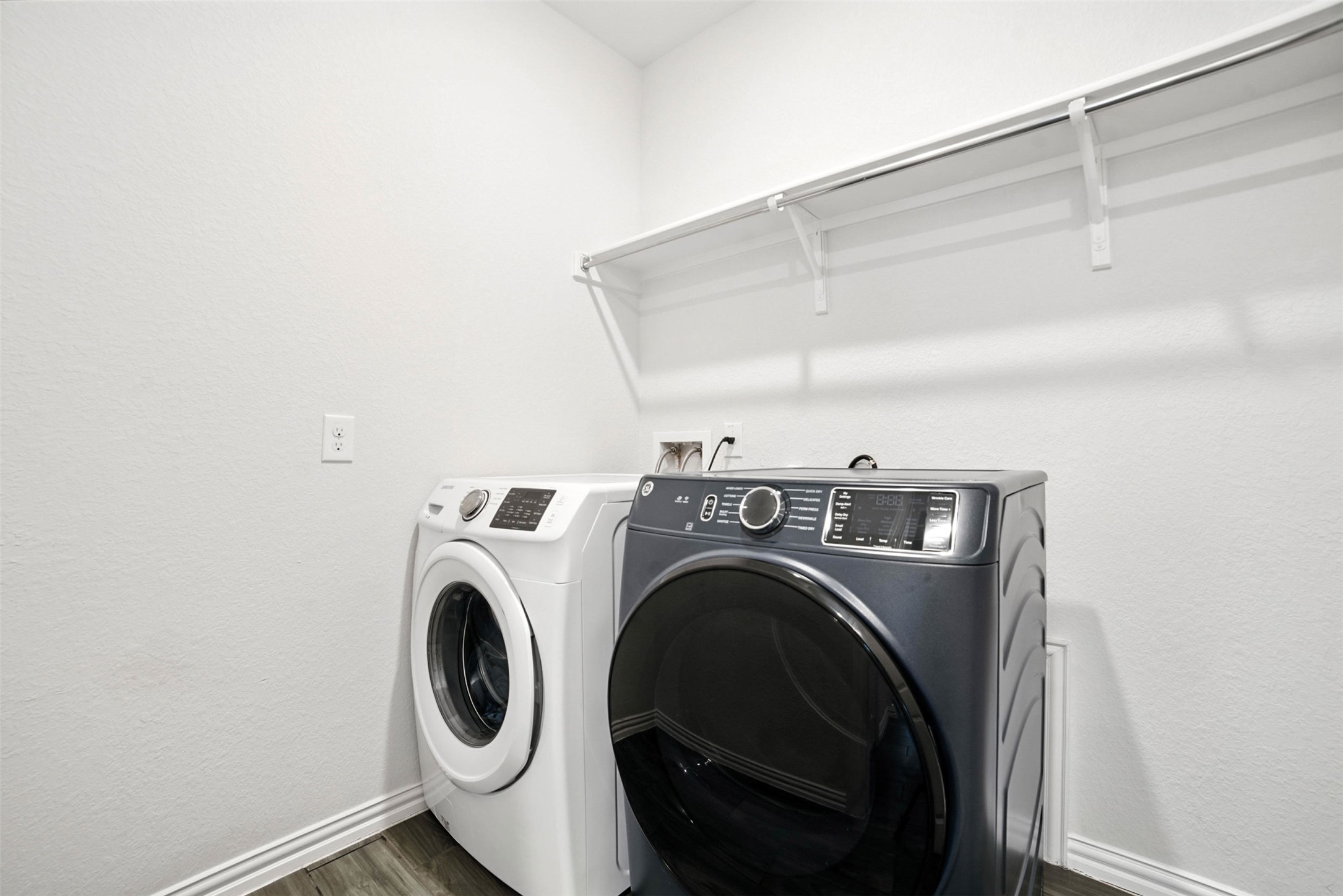 3054 Columbus Loop Round Rock, TX 78665 - Photo 15 of 40 Laundry area with washing machine and clothes dryer and dark wood-style floors