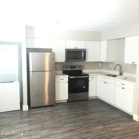 a kitchen with a refrigerator stove and microwave