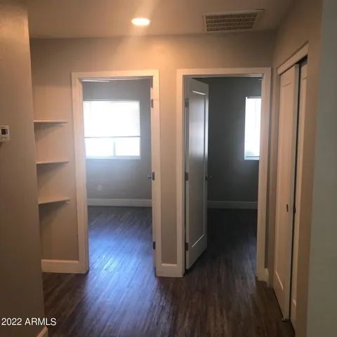 a view of hallway with wooden floor