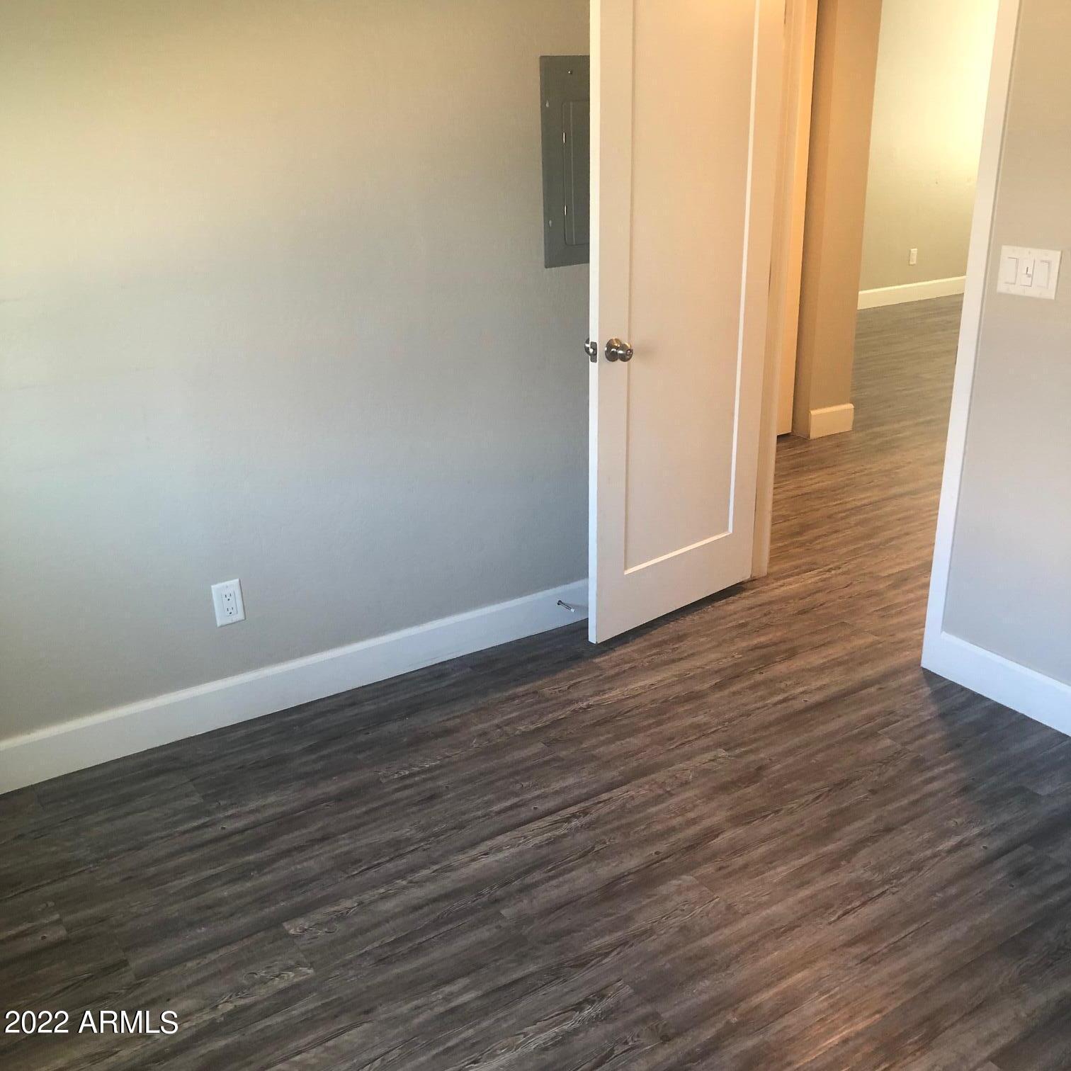 2246 West Southern Avenue, Unit 17 Phoenix, AZ 85041 - Photo 5 of 7 a view of a room with wooden floor