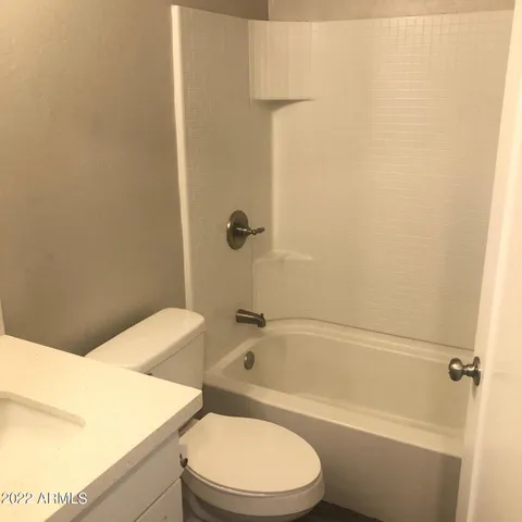 a bathroom with a toilet and a bath tub