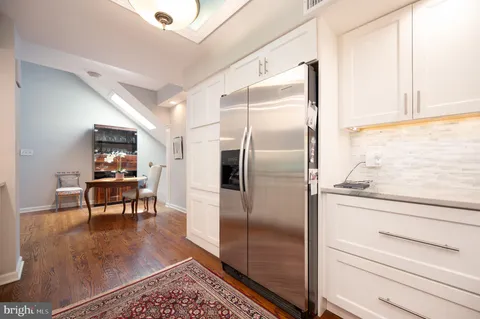 a kitchen with metallic refrigerator and table