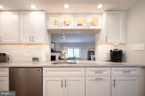 a kitchen with stainless steel appliances white cabinets and a sink