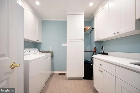 a view of a storage & utility room with a washer dryer