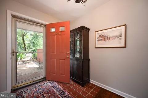 a view of a hallway with wooden floor and a bedroom
