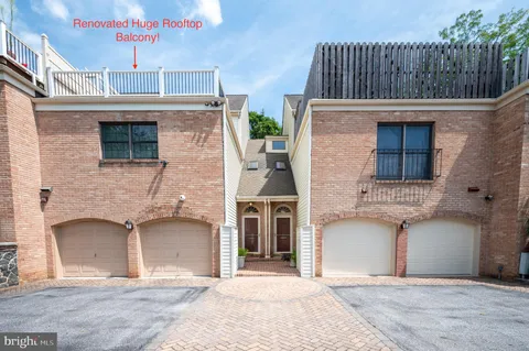 a front view of a house with glass windows and garage