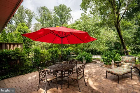 a view of backyard with seating space and wooden deck