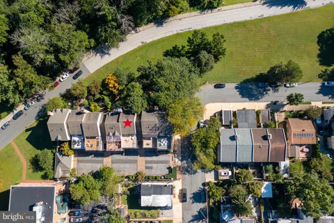 an aerial view of a building with garden space and street view