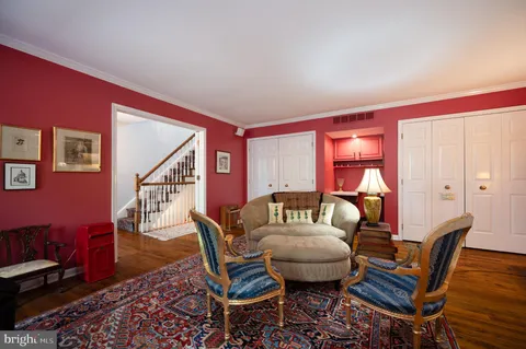a living room with furniture a rug and a window