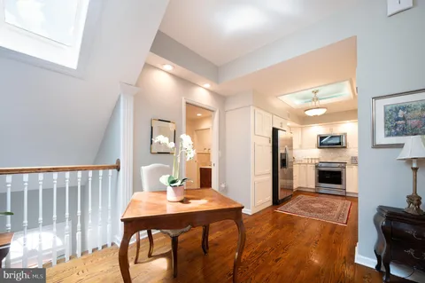 a kitchen with stainless steel appliances kitchen island granite countertop a refrigerator a stove a sink dishwasher with a dining table and chairs