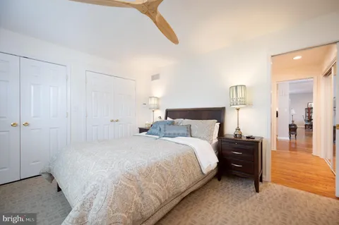 a bedroom with a bed and a night stand