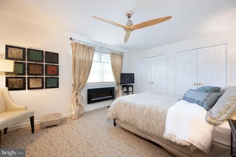 a spacious bedroom with a bed and a couch