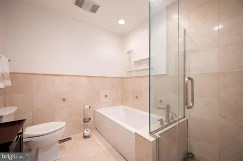 a bathroom with a bathtub and a toilet