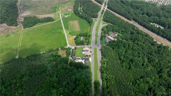 an aerial view of a residential houses with outdoor space and street view