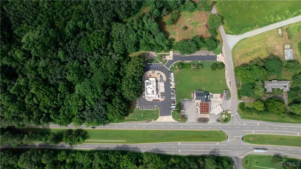 an aerial view of residential houses with outdoor space and trees