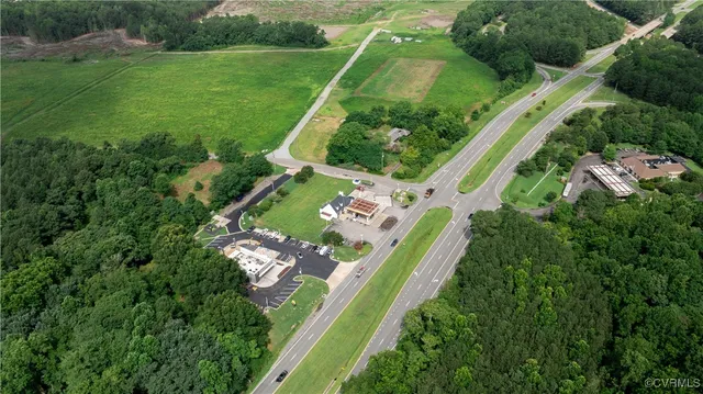 an aerial view of a house with a yard