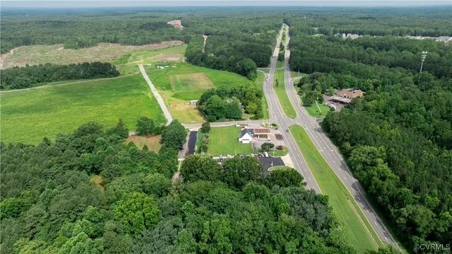 an aerial view of a house with a yard