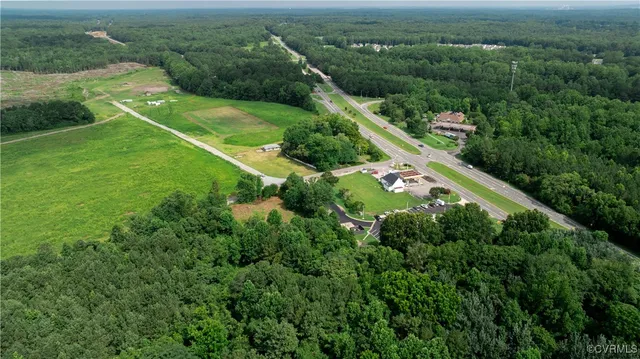 an aerial view of a residential houses with outdoor space and street view