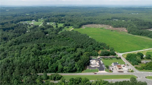 an aerial view of a houses with a yard