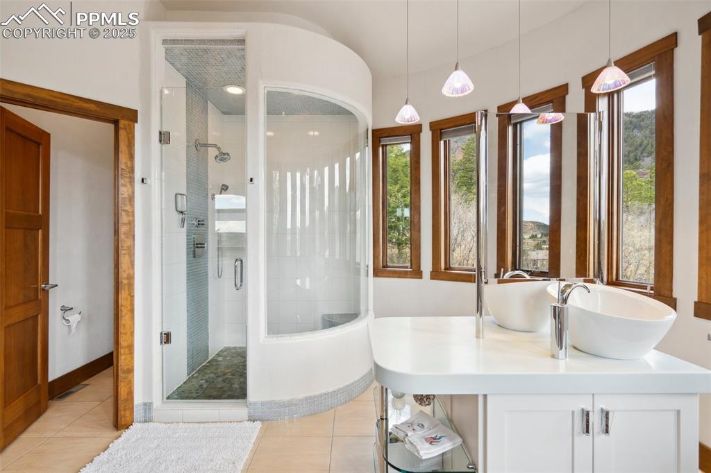 18496 Pixie Park Road Monument, CO 80132 - Photo 18 of 50 a bathroom with a granite countertop sink and a large mirror