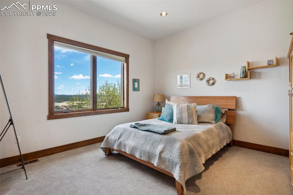 18496 Pixie Park Road Monument, CO 80132 - Photo 21 of 50 a bedroom with a bed and window