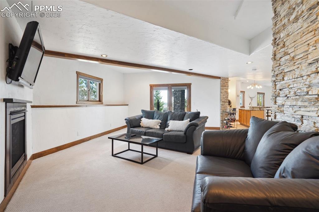 18496 Pixie Park Road Monument, CO 80132 - Photo 31 of 50 a living room with furniture and a flat screen tv