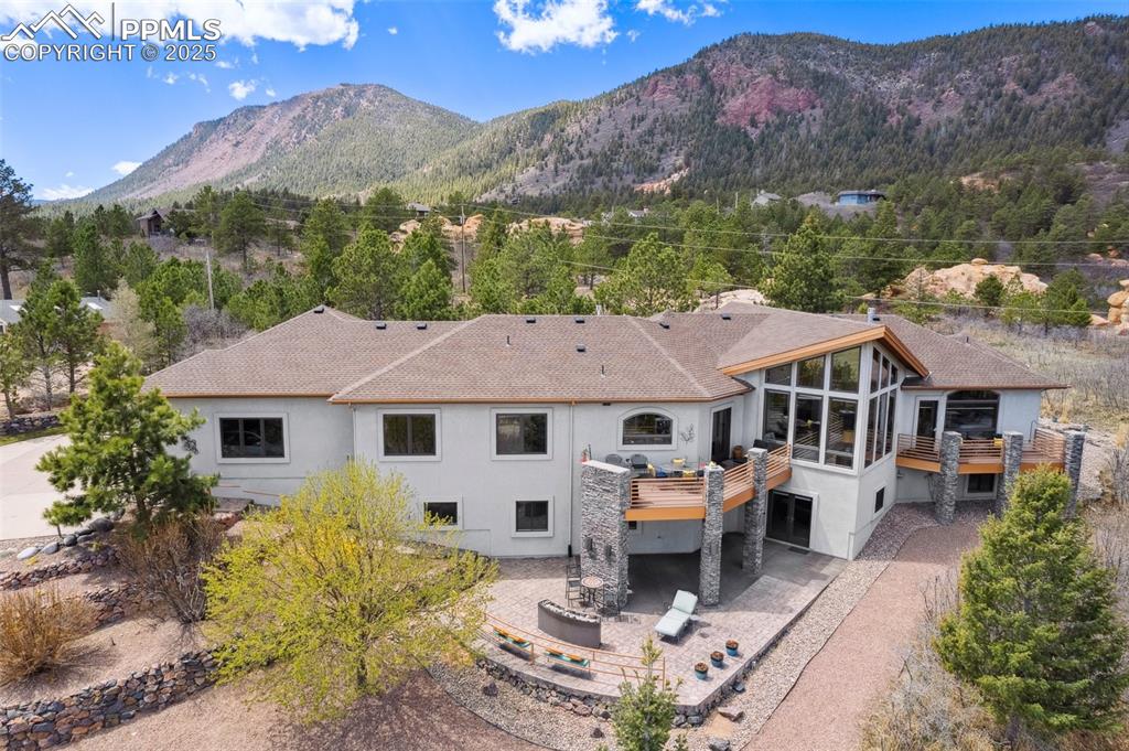 18496 Pixie Park Road Monument, CO 80132 - Photo 46 of 50 a front view of a house with a yard and mountain view
