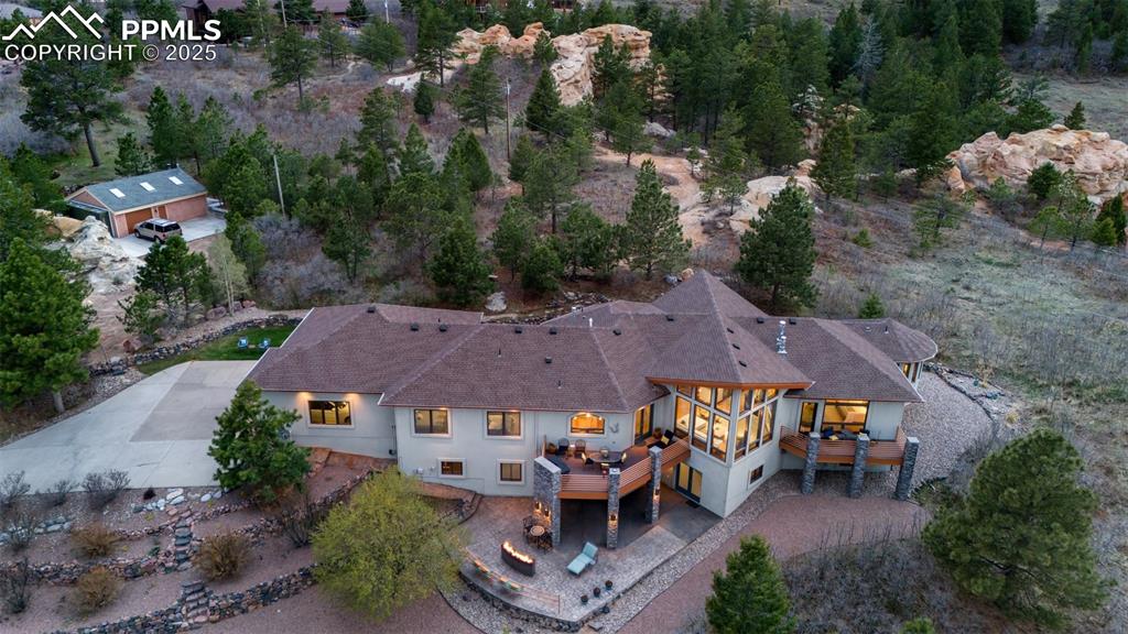 18496 Pixie Park Road Monument, CO 80132 - Photo 47 of 50 an aerial view of a house with a garden and mountain view