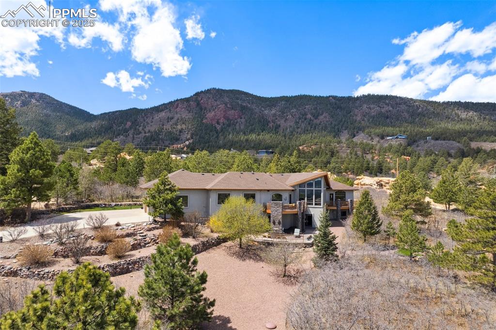 18496 Pixie Park Road Monument, CO 80132 - Photo 49 of 50 a view of a house with a yard and a pool