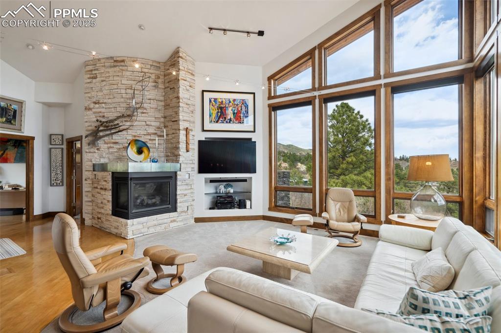 18496 Pixie Park Road Monument, CO 80132 - Photo 8 of 50 a living room with fireplace furniture and a flat screen tv