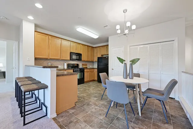a view of a dining room with furniture and a chandelier
