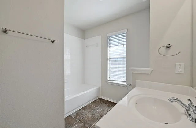 a bathroom with a sink and a bathtub